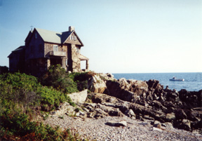 House on rocky shore in Maine; cruise to Maine
